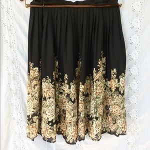 Black pleated skirt with neutral floral pattern